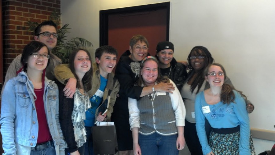 (pictured from left to right) Jordyn Iger, Joe Pelligrino, Allie Latini, Ryan Schulte, Kate Batik, Briana Cerrana, Breze McLaughlin, and Nicole Heneveld, join poet Tori Derricotte (center) at Adelphis National Poetry Day conference